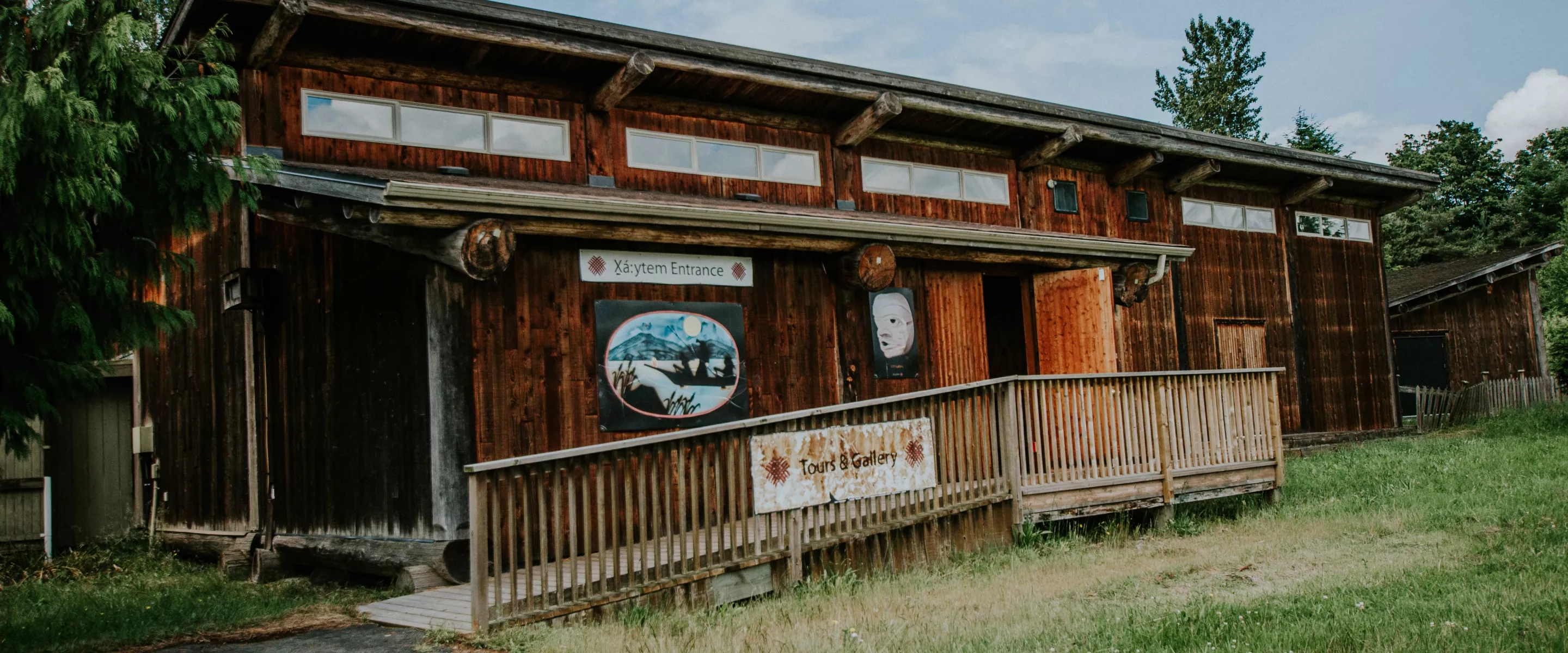 A wooden longhouse on a sunny day