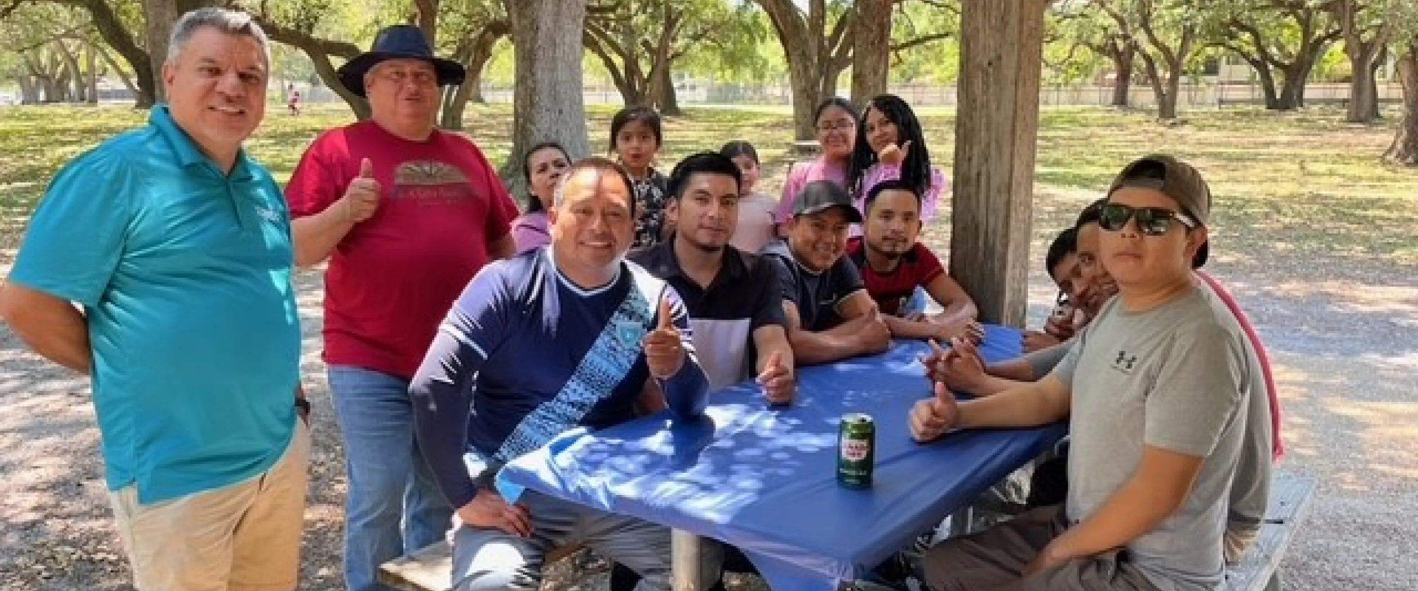 Group of people sit around a table. 