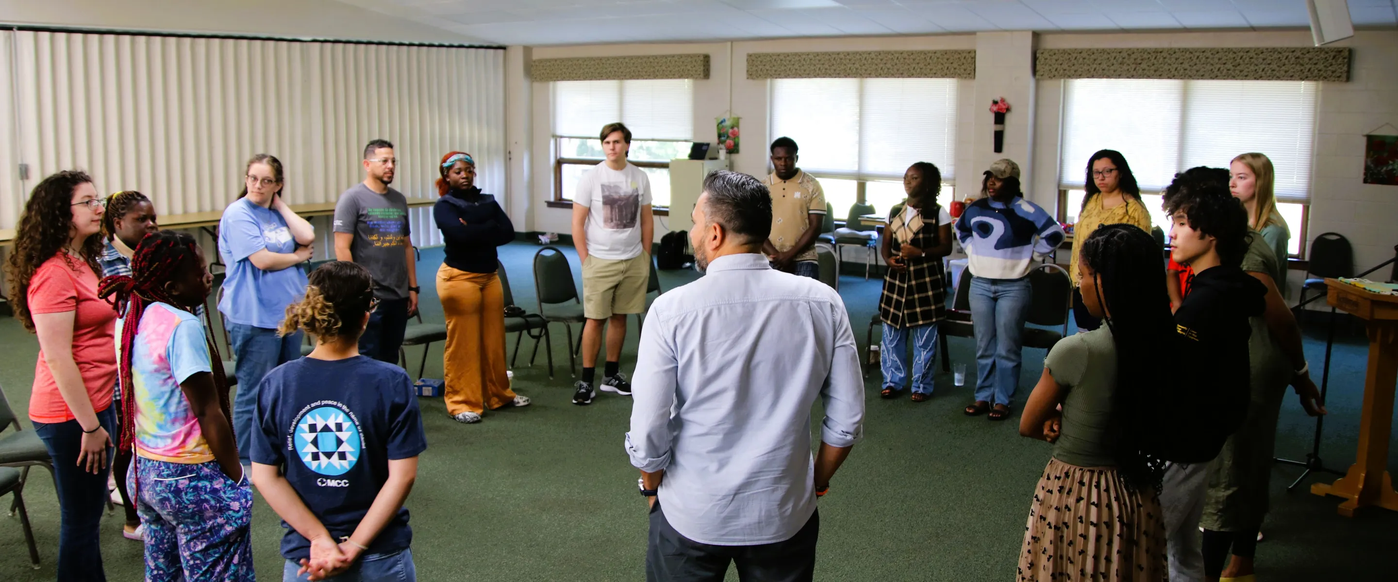 people stand in a circle to talk together