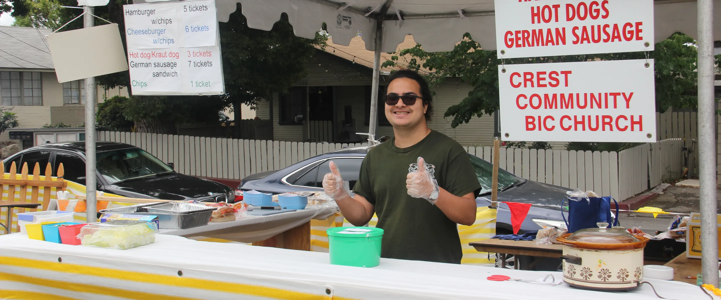 a male standing in front of a food stand