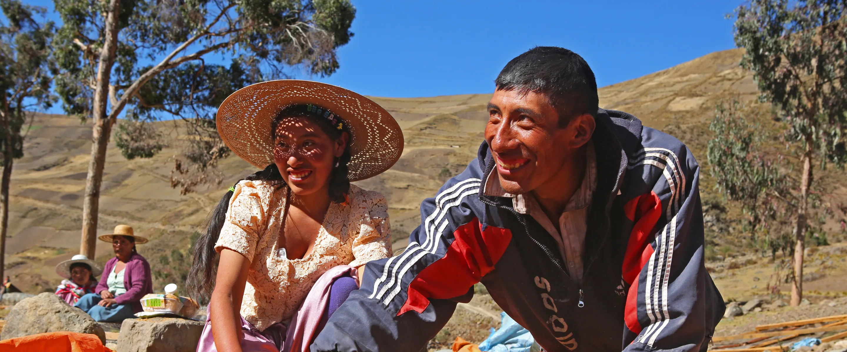 Sofia Perez, left, helps her brother, farmer German Perez Saénz rotate his maca crop as it dries.