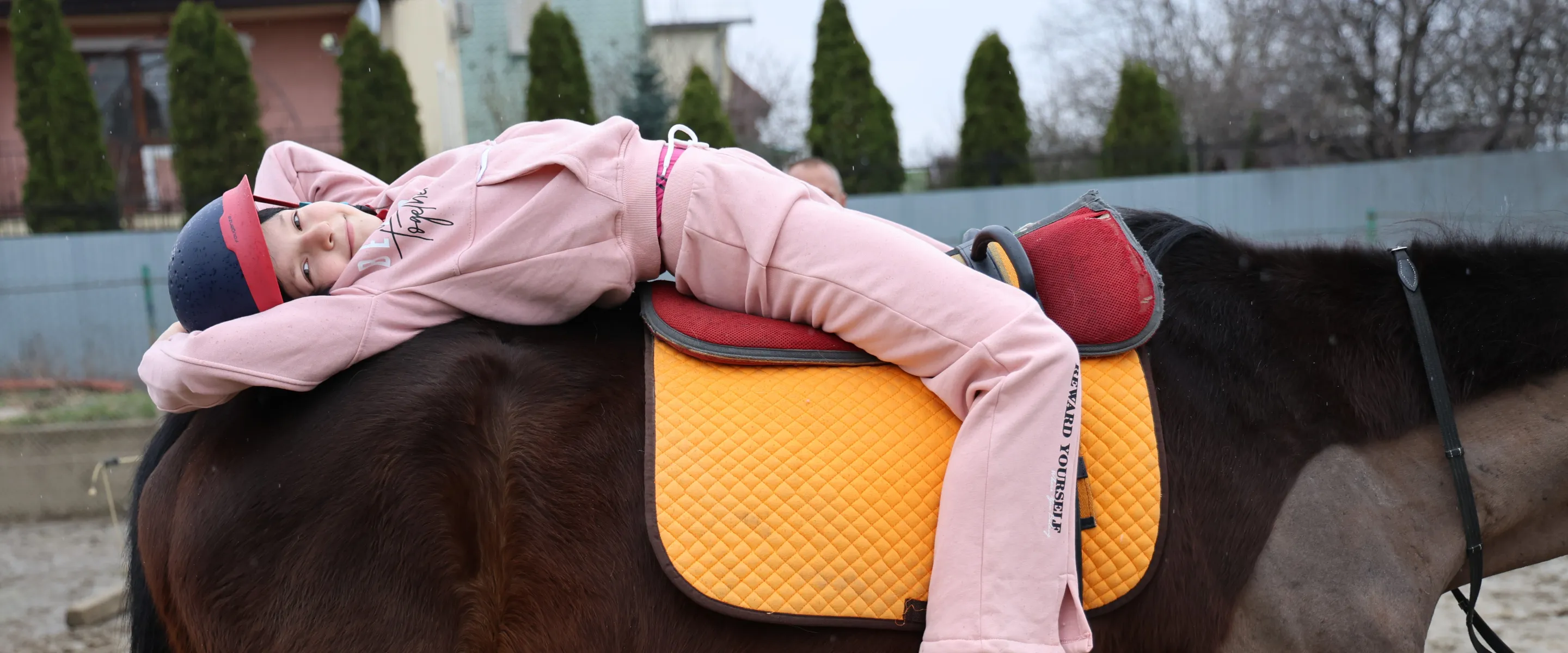 a smiling girl riding a horse