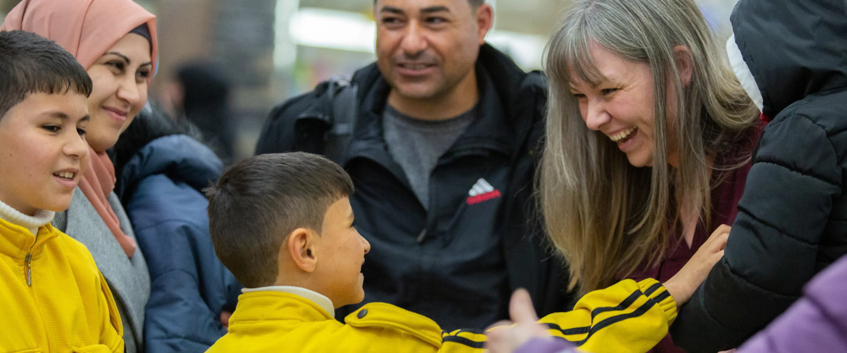 A family greeting friends at the airport