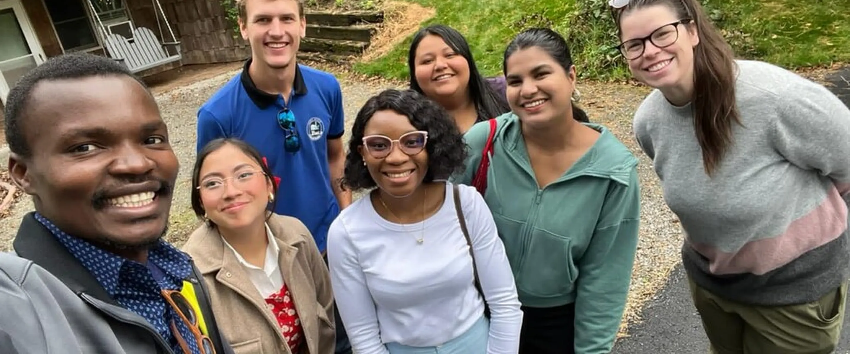 A group of people gather for a selfie. 