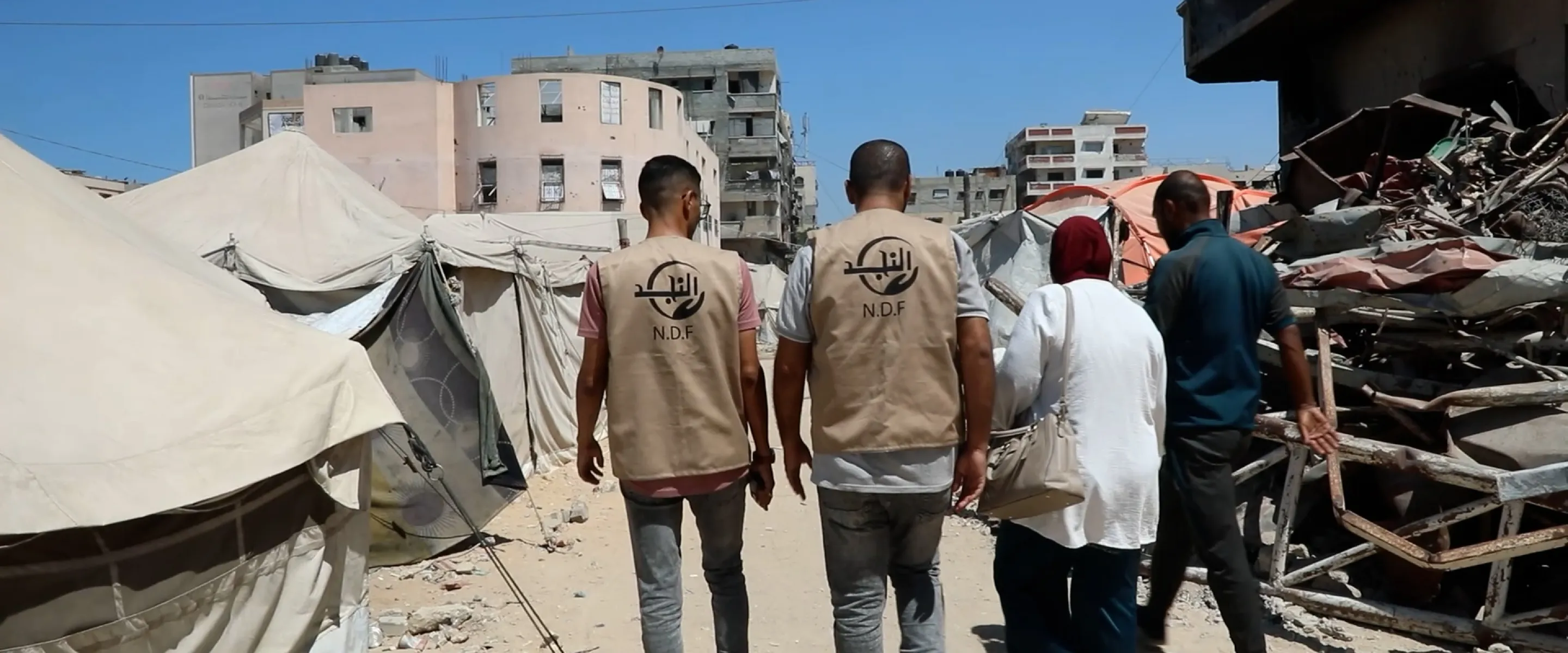 A group of people walking amidst destruction