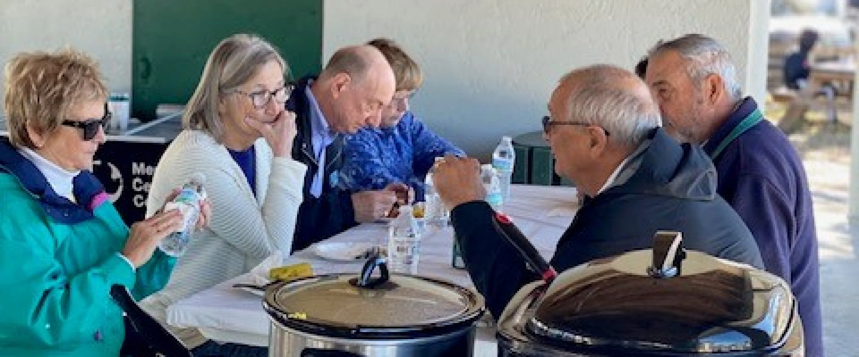 People gathered around a table, eating together. 