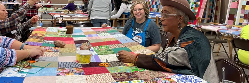 volunteers tie knots in comforters