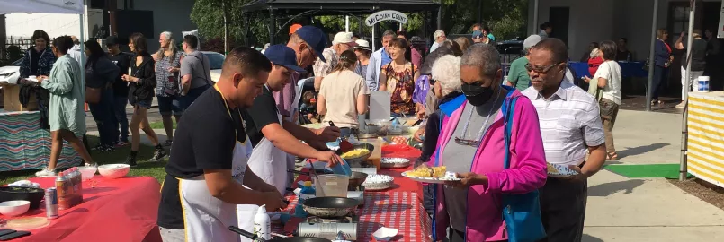 People lining up to get omelets for breakfast.