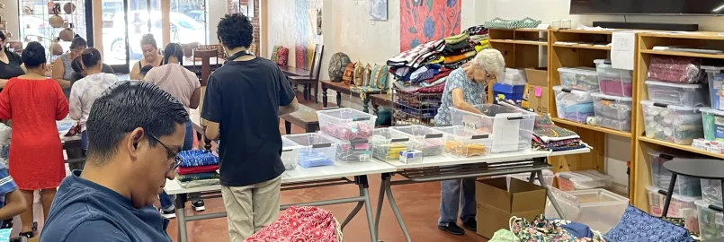 Group of people packing and checking school kits