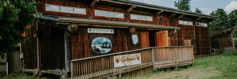 A wooden longhouse on a sunny day