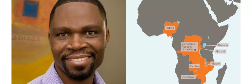 photo of man smiling at camera next to map of Africa with some countries highlighted