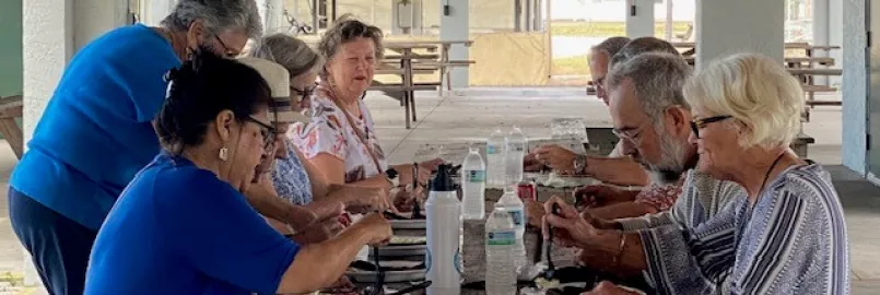 MCC alumni eat BBQ. 