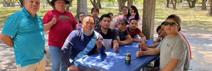 Group of people sit around a table. 