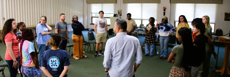 people stand in a circle to talk together