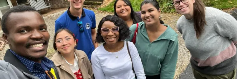 A group of people gather for a selfie. 