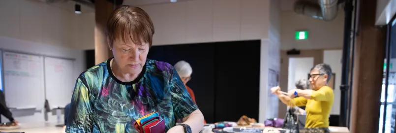 Two women pack dignity kits at a packing event in Manitoba