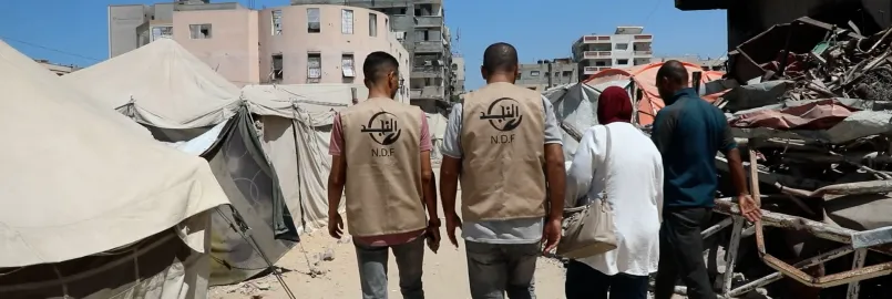 A group of people walking amidst destruction