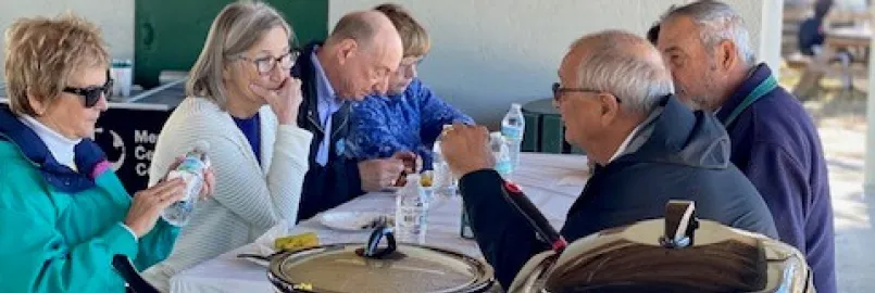 People gathered around a table, eating together. 