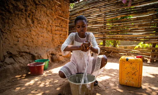 A woman washing clothes with water