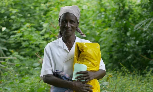 A woman holding a bag of emergency food