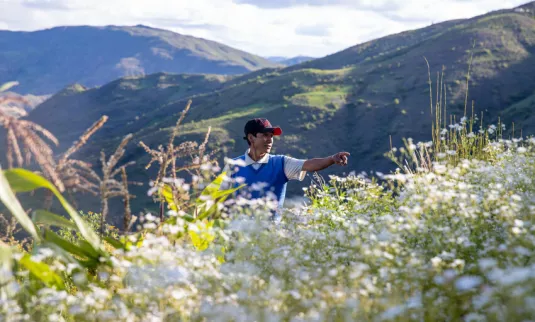 A man standing in a field pointing