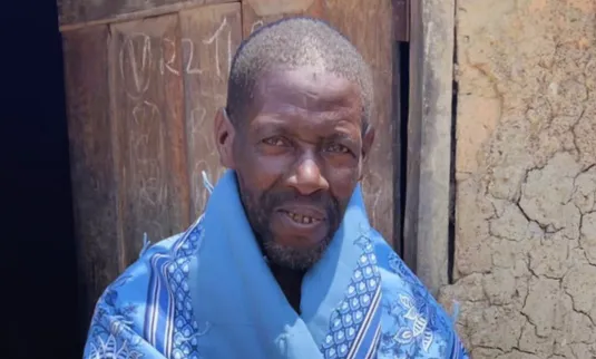 Man posing with comforter
