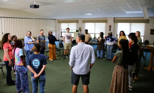 people stand in a circle to talk together