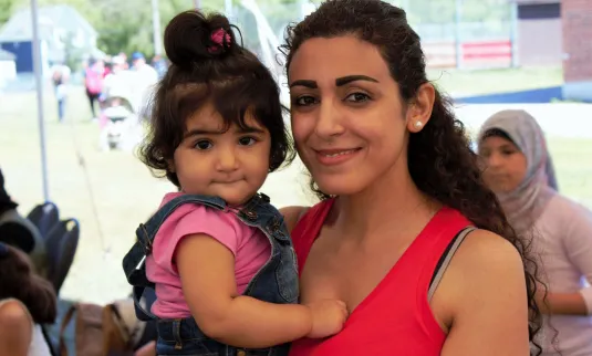 An adult holds a child.