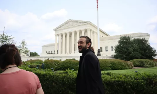Galen Fitzkee, Legislative Associate for MCC's Peace & Justice Ministries, strolls towards the Russell Senate Office Building to do climate advocacy visits with members of Congress on August 2, 2023.