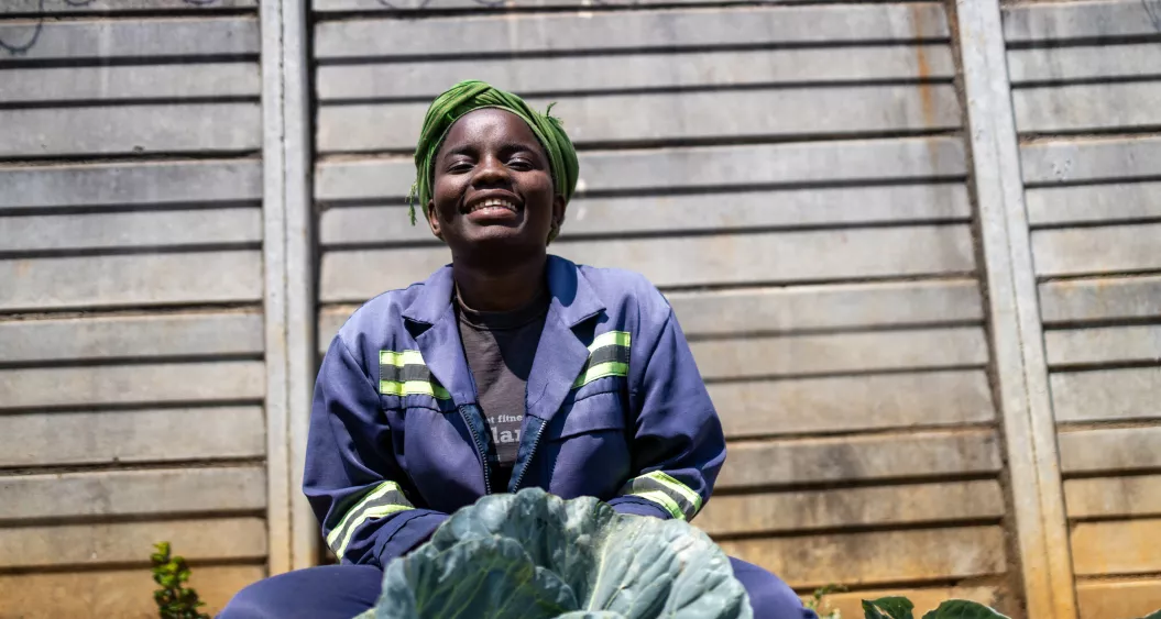 A woman smiling in her garden