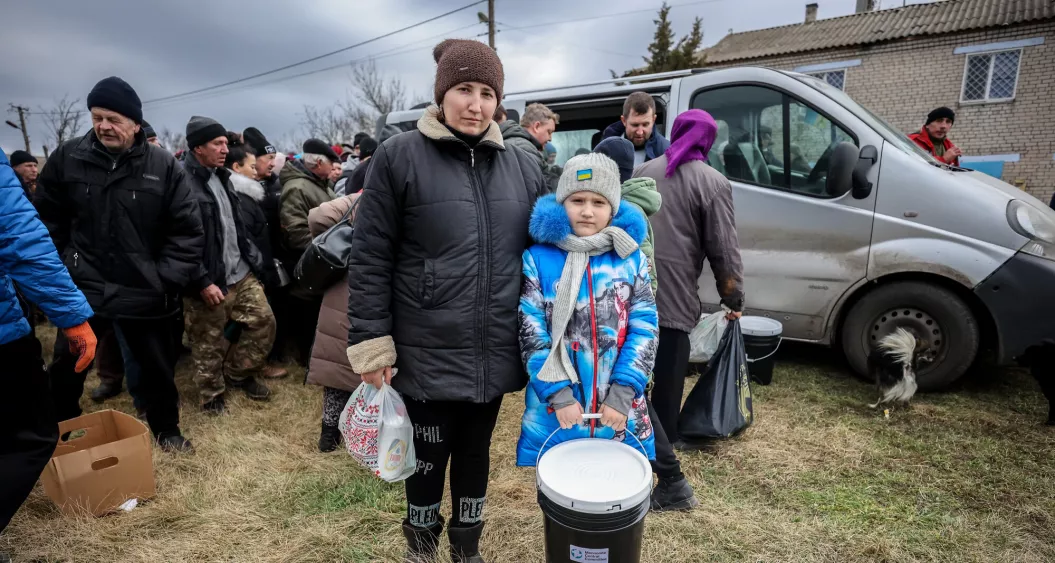 Woman and child holding disaster relief supplies