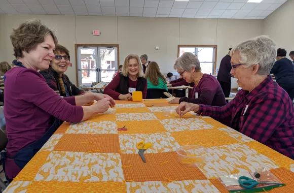 Jan Amstutz, Vicki Unrau, Darla Banman, Barb Abrahams and Janice Voth work together to tie the last few knots in this comforter. They participated in the Great Winter Warm-up on Jan. 18, 2020 at Tabor Mennonite Church in rural Newton, Kansas.