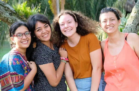 A group of four young women smiling for the camera