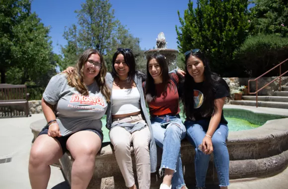 On the fifth day of their pilgrimage, left to right, Alecia Espinosa, Karina Morales, Sarai Uriostegui, and Betsy Olvera sit at the fountain in the center of César E. Chávez National Monument. The day’s theme is narrative and storytelling.