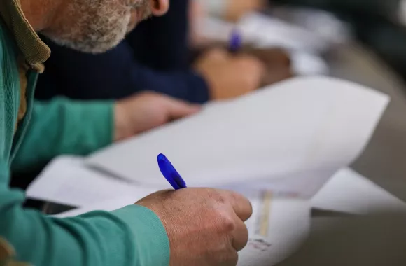A participant fills out paperwork.