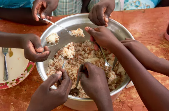 Students at Loreto Rumbek School enjoy a meal made with MCC canned turkey.