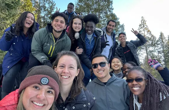 A group of young adults from different nationalities take a group selfie