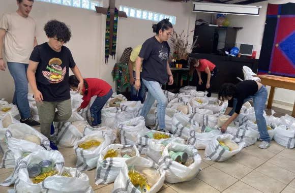 MCC team fills grocery bags to distribute to families in Ecuador.