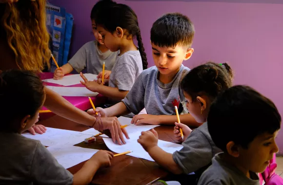 Children complete their final exams in a kindergarten class in Lebanon.