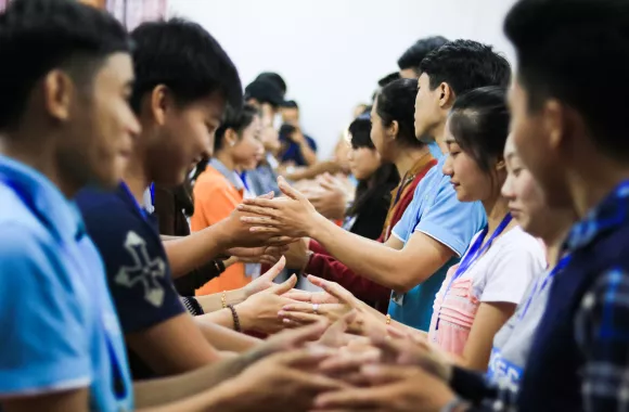 A group of people holding hands