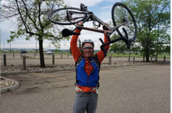 A man holding a bicycle