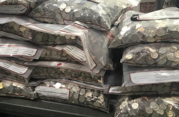 A pile of plastic bags filled with coins