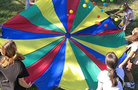 Group playing with a parachute