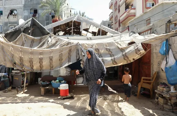 woman walking in front of tent