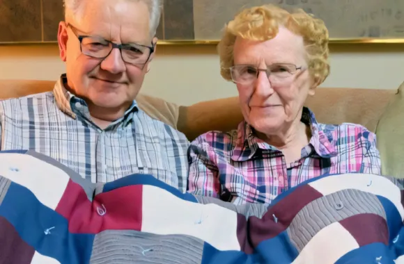 People posing with comforters