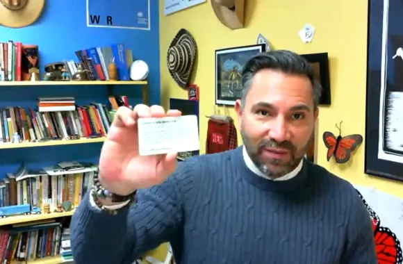 A person his holding a card up to the camera that says "Know Your Rights."