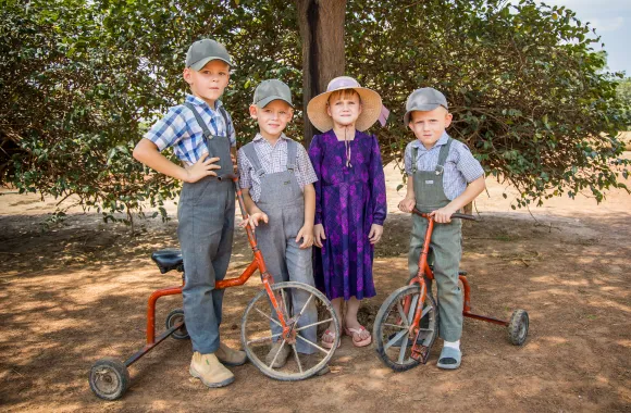 Group of children standing around a bike