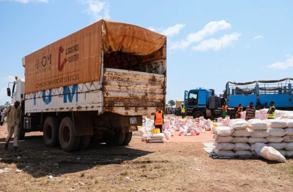 Volunteers work to move the bags of sorghum off the truck, and organize them with the other food items for program participants to collect. MCC partner Episcopal Church of South Sudan – South Sudane