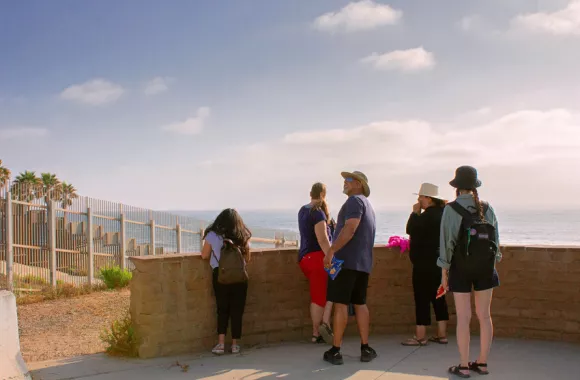 The Multicultural Peace Collaboration (MPC) group views the border wall between Mexico and California.