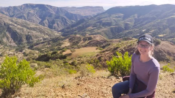 A young woman sitting in the Bolivian hillside